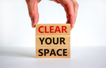 Clear your space symbol. Wooden blocks with words 'Clear your space'. Beautiful white background, businessman hand. Business, clear your space concept, copy space.