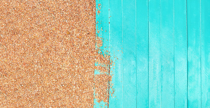 Marine banner. Turquoise wooden planks of pier with beach pebble sand. Travel and tourism. Copy space