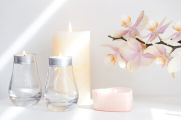 Burned candles and orchid flowers. Calm and relax concept.