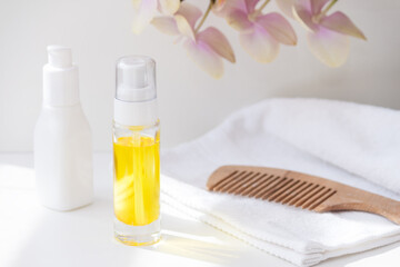 Hair care concept. Argan oil, comb in sunny day.