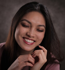 Happy girl against a grey background - studio photography