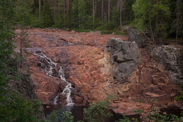 A usually lager waterfall is very small now. Drought concept