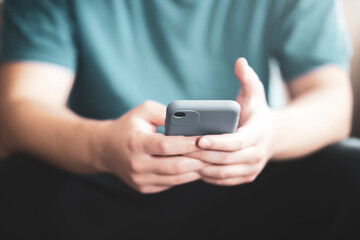 Teenager holding mobile phone in hand