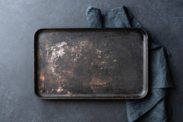Old rusty black baking sheet background, top view, copy space
