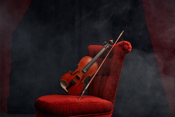 Violin in retro style and bow on the chair, nobody