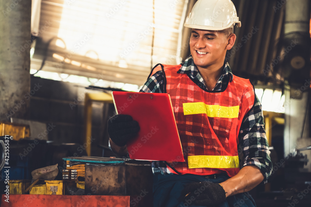 Poster manufacturing worker working with clipboard to do job procedure checklist . factory production line 