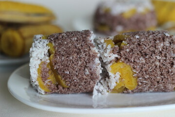Steamed finger millet flour cake with a generous layer of fresh coconut in between. Locally known as Ragi puttu. Served with steamed plantain.