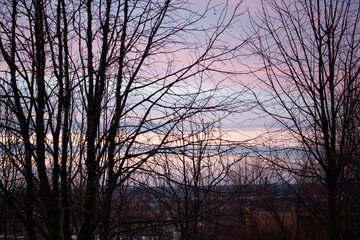 Clouds of different colors in the light of the sunset in April