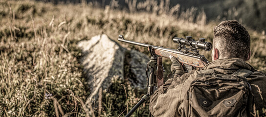 Hunting period. Hunter with hunting gun and hunting form to hunt. Hunter is aiming. Shooter...