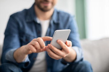 Modern smartphone in unrecognizable man hands, copy space