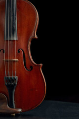 Brown wooden violin in retro style, closeup view