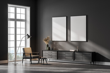 Grey living room interior with armchair, drawer and window, two posters