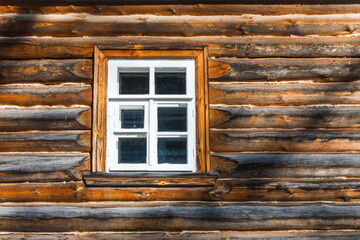 Fototapeta na wymiar white window of a wooden house