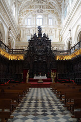 Interior with altar and aisle and benches in Great Mosque of Cordoba, Spain