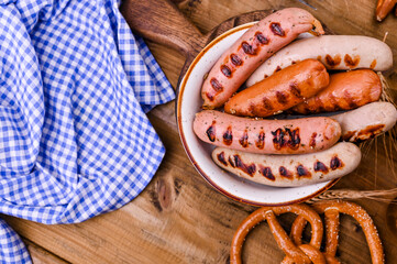 Traditional bavarian grilled sausages with mustard for oktoberfest celebration. Wooden background and national food. Top view. Copy space.