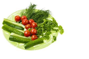 Close up view of fresh sliced cucumbers, cherry tomatoes, dill and parsley lying on a plate  isolated on white background.