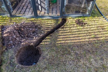 Close up view of laying of automatic watering for plants in a vegetable garden for green house. Sweden.