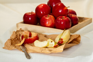 Sliced red apple with its skin on paper