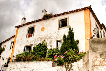 Narrow and colorful streets, facades and balconies of Obidos