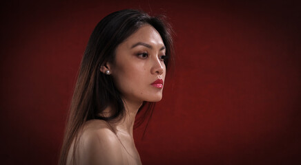 Fototapeta premium Sexy close-up of a young Asian woman with bare shoulder - studio photography