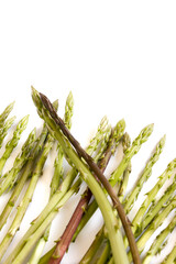 A row of green asparagus on a white background.