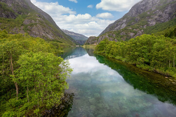 Naklejka na ściany i meble An idyllic green rural landscape scene from the mountains of Norway