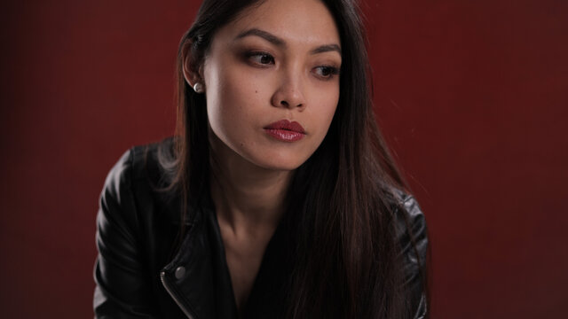 Young pretty woman in black leather jacket posing for the camera - studio photography
