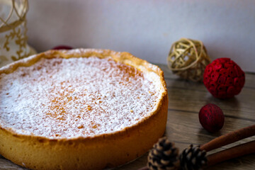 Round sweet pie made of cottage cheese and pumpkin, sprinkled on top with powdered sugar