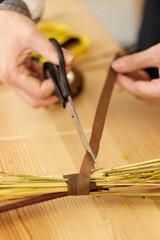 florist makes beautiful bouquet of dried flowers