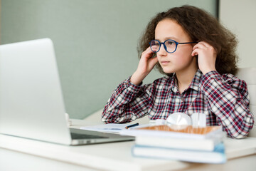 Caucasian teenage girl in headphones make note handwrite study distant