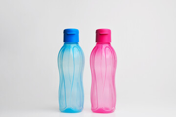 Sport Watter bottle. Water Colored Plastic Bottles. Colored Transparent Liquid Water Bottle Container in White Isolated Background.
