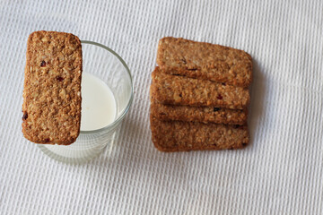 snack healthy cookies with milk on white tablecloth