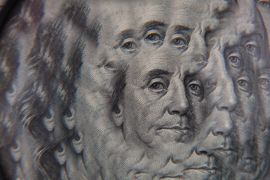 Benjamin Franklin from US 100 dollar banknote through kaleidoscope prism
