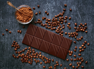 Chocolate bar, cocoa powder and fresh fried coffee beans, top view