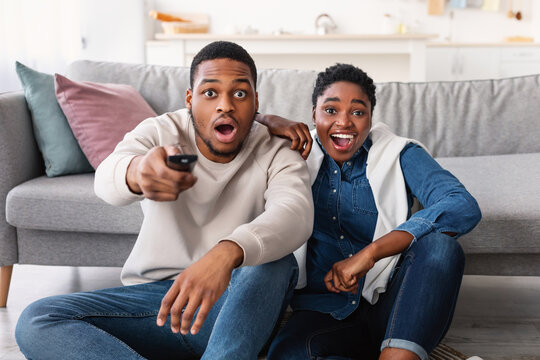 Excited Black Couple Spending Time Together Watching Tv