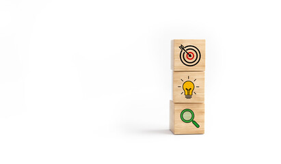 Concept of business strategy and action plan. Wooden cube block with icon target, light bulb and...