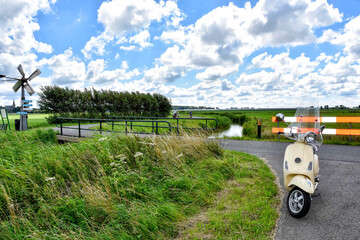 Enjoy touring with your scooter in the Dutch landscape with the wind in your hair and the sun on your face. Netherlands, Holland, Europe