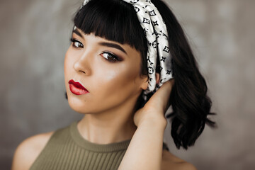 Beautiful young brunette girl with fair skin with beautiful makeup and red lips. Model beauty fashion portrait