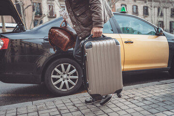 Business man leaving for airplane departure boarding taxi with carry-on luggages packing truck of car for travel holiday vacation.