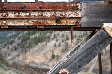 A detail of the weathered wood and rusted metal fittings on the  historic  Old Bridge across the Fraser River at Lillooet British Columbia, Canada.