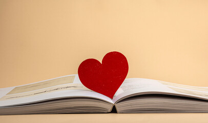 a red wooden heart on centerfold book