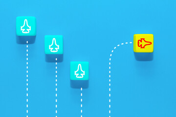 New ideas creativity and different innovative solution. A group of wooden cubes with airplane icons, one airplane flying in the other direction