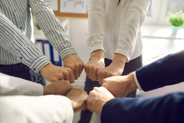 Obraz premium Teambuilding. Closeup shot of different ethnicity business people hand fist bumping together showing collaboration, support, unity, partnership, motivation and effective coworking for startup success