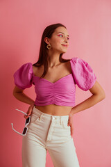 Elegant fashionable woman wearing trendy fuchsia color blouse with puff sleeves, white  jeans,...