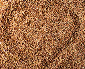 Heap of dry buckwheat groats isolated on white background. Healthy product. Vegetarian food. Raw buckwheat in the shape of a heart. Happy Valentines day. Love. Top view