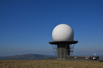 a view of the radar station at Titterstone Clee summit with the sky clear blue