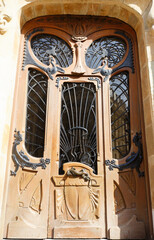 Fototapeta na wymiar Old ornate door in Paris - typical old apartment buildiing.
