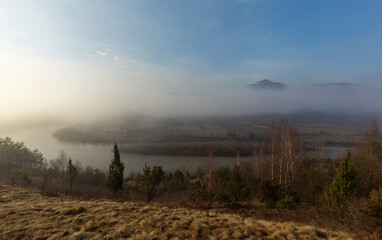 Sunrise over the mountains shrouded in fog. Landscape of the mountain river Stryi, Carpathian mountains, Ukraine, Europe. Carpathian mountains, Beskydy region view of the valley of the river Stryi.