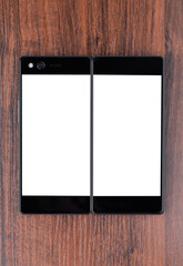 Smartphone with a blank white screen. New popular smartphone on a wooden surface.