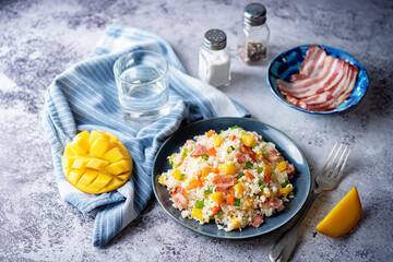 Fried bacon mango Red bell pepper rice in a plate